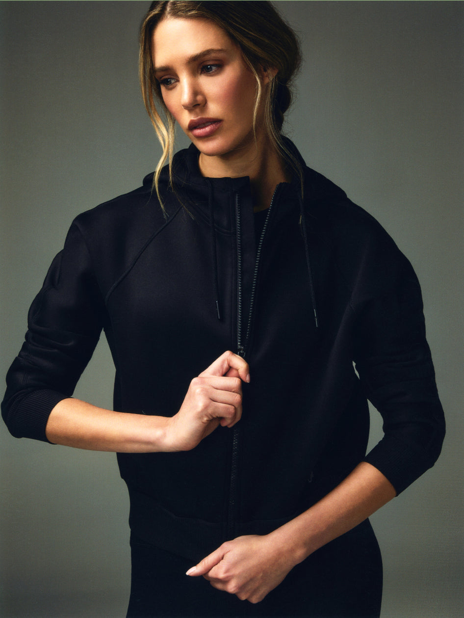 Black Women's Full-Zip Performance Hoodie - Zip Detail Close-Up On Model | Greyson Clothiers