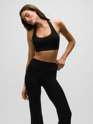 Black Stretch Venus Sports Bra Scoop Neck - Side Angle On Model | Greyson Clothiers