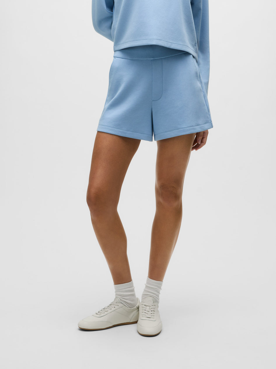 Wolf Blue Cotton Ojai Trouser Short - Front Close-Up On Model, Welt Pocket & Hem Detail | Greyson Clothiers